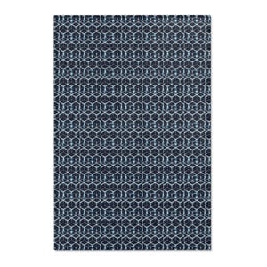 May include: A rectangular textile with a repeating geometric pattern. The design features a series of interconnected cubes in shades of navy blue and white. The overall effect is a textured, three-dimensional appearance.