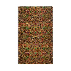 May include: A rectangular decorative textile with an ornate, repeating pattern. The design features gold-colored filigree with red, green, and purple accents, and small pearl-like embellishments against a black background.