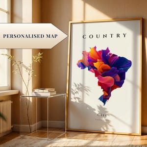 May include: A framed print featuring a colorful abstract map of a country, with the word "COUNTRY" at the top. The map is composed of vibrant hues of orange, pink, purple, and blue. The words "Personalised Map" are in a banner.