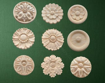 May include: Nine small, unfinished wooden floral carvings in various designs. The carvings are round and feature detailed petal and leaf patterns, perfect for decorative woodworking projects. The natural wood color provides a neutral base for painting or staining.