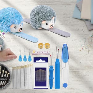 May include: A collection of sewing tools and accessories, including hedgehog pin cushions, needles, seam rippers, and a measuring tape. The items are in various shades of blue, white, and gold, perfect for crafting and sewing projects.