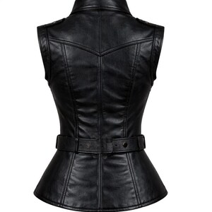 May include: Black leather vest with a tailored fit. Features a notched collar, sleeveless design, and a belted waist. The vest has a peplum-style hem and decorative stitching details. A stylish outerwear piece.