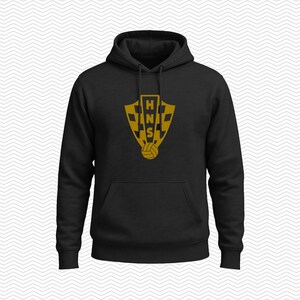 May include: A black hooded sweatshirt featuring a gold-colored shield emblem on the chest. The emblem displays a checkered pattern, the letters HNS stacked vertically, and a small soccer ball icon at the bottom. The hoodie includes a front pocket.