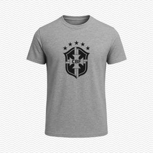 May include: A heather gray short-sleeve t-shirt featuring a black graphic print on the chest. The design displays a shield emblem with the letters CBF in the center, topped by five stars arranged in a semi-circular arc above the shield crest.