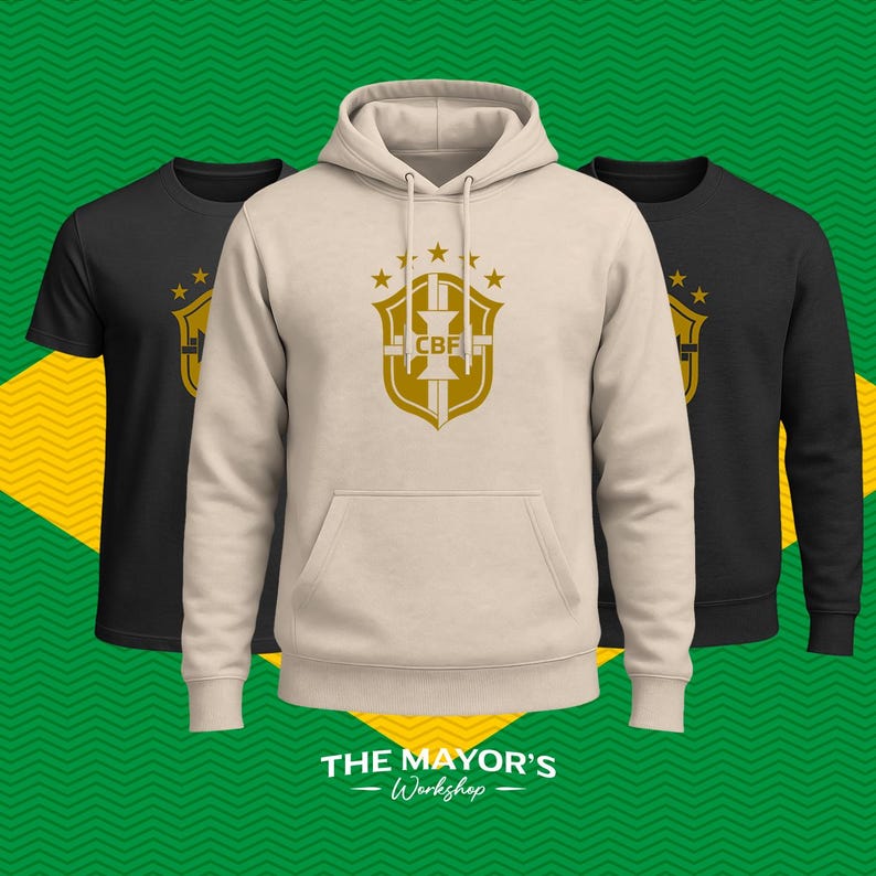 May include: A beige hooded sweatshirt with a front kangaroo pocket and a gold CBF shield logo on the chest, flanked by two black shirts featuring the same gold logo. The text THE MAYOR'S Workshop is printed in white at the bottom of the image.