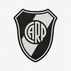 May include: A shield-shaped patch featuring a black and white textured design. The emblem displays a central circle containing the letters CARP in a bold, sans-serif font, intersected by a diagonal white band against a black background.