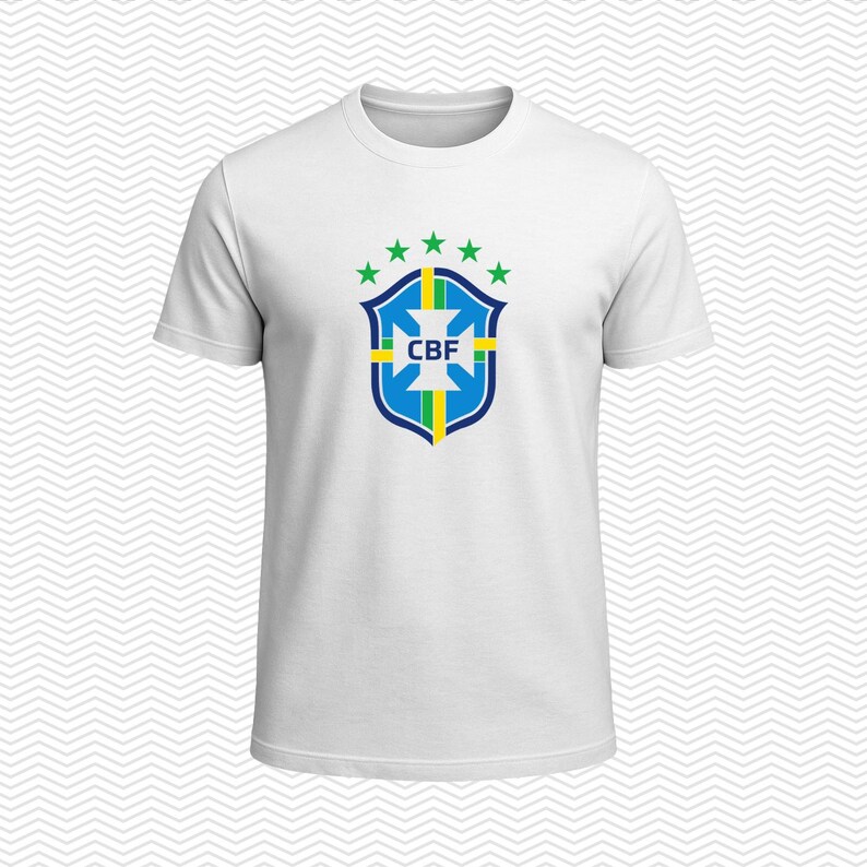May include: A white short-sleeved t-shirt featuring the blue, green, and yellow CBF crest centered on the chest. The crest is topped with five green stars arranged in a semi-circle. The shirt has a classic crew neckline and a plain white back.
