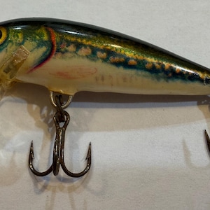 May include: A rustic wooden sign with the text "Welcome to our home" in white lettering. The sign features a distressed finish and a simple, inviting design, perfect for a front porch or entryway.