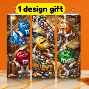 May include: A stainless steel tumbler featuring a colorful design with M&M's characters in various poses. The design includes a blue M&M holding a large blue crystal, a yellow M&M surrounded by candies, and other characters. The text "1 design gift" is at the top.