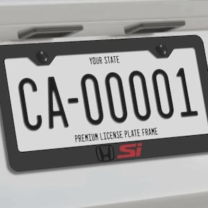 May include: A license plate with the text "CA-00001" in black on a white background, framed by a black border. The frame includes the text "YOUR STATE" and "PREMIUM LICENSE PLATE FRAME". The Honda Si logo is at the bottom.