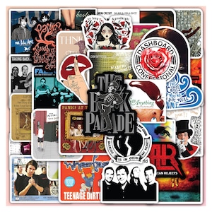 May include: A collection of colorful stickers featuring various band logos, album art, and graphics. The stickers include text such as "The Black Parade", "Dashboard Confessional", and "Teenage Dirtbag". The stickers are arranged on a pink background.