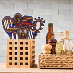 Elegant wooden cooking utensils set made from premium Pakkawood, featuring spoons, spatulas, ladle, and turner arranged as modern kitchen decor for cozy USA homes, perfect for rustic, boho, and minimalist kitchens with natural wood aesthetics and nonstick-safe cookware use.
