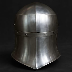 May include: A polished steel medieval helmet with a rounded top and a flared lower section. The helmet features a horizontal band with rivets and a smooth, reflective surface. The design is symmetrical and the overall aesthetic is historical.