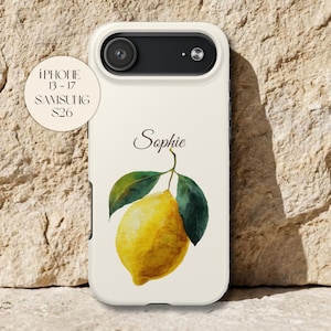 May include: A cream-coloured phone case with a watercolour lemon design, green leaves, and the name "Sophie". Compatible with iPhone 13-17 and Samsung S26 models. The case has a camera cutout.