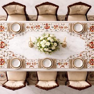 May include: A rectangular dining table with a white marble top featuring an intricate floral inlay border in shades of red, orange, and green. The table is surrounded by eight upholstered chairs with cream cushions and dark wood frames.