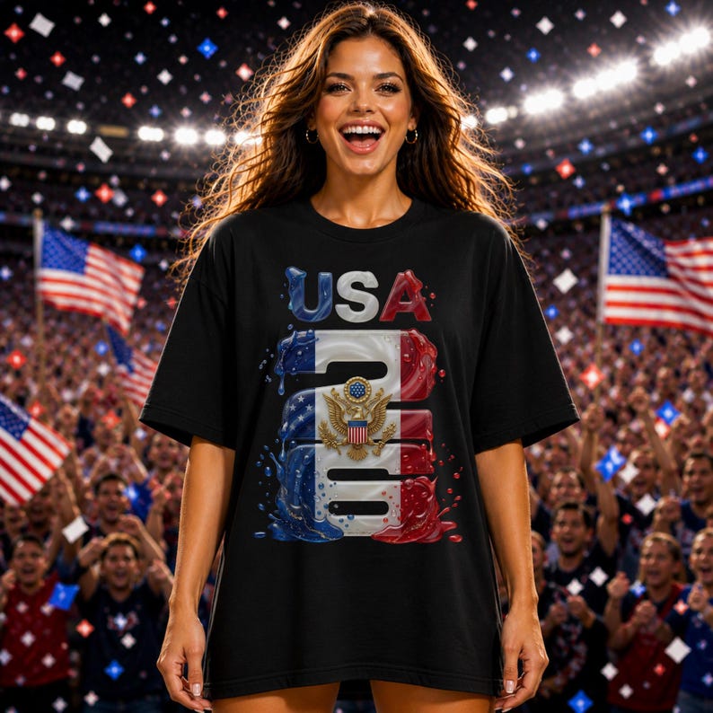 May include: Black t-shirt with a patriotic design featuring the word "USA" in red and blue, and the number "246" with the American flag colors. The shirt includes the American eagle emblem. The design is on the front of the shirt.