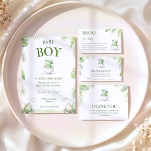 May include: A baby shower invitation set with a dinosaur theme. The invitation reads "Baby Boy is Hatching Soon" with event details. Additional cards include "Books for Baby," "Diaper Raffle," and "Thank You," all featuring a dinosaur hatching from an egg.