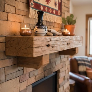 May include: A rustic fireplace with a wooden mantel, adorned with a black and white vase, a small potted cactus, and lit candles. The fireplace is constructed of stone bricks, and a colorful woven tapestry hangs above.
