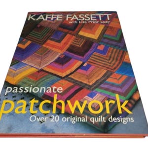 May include: A hardcover book titled "Kaffe Fassett Passionate Patchwork" with a colorful quilt design on the cover. The cover features the text "passionate patchwork" in yellow, and "Over 20 original quilt designs".