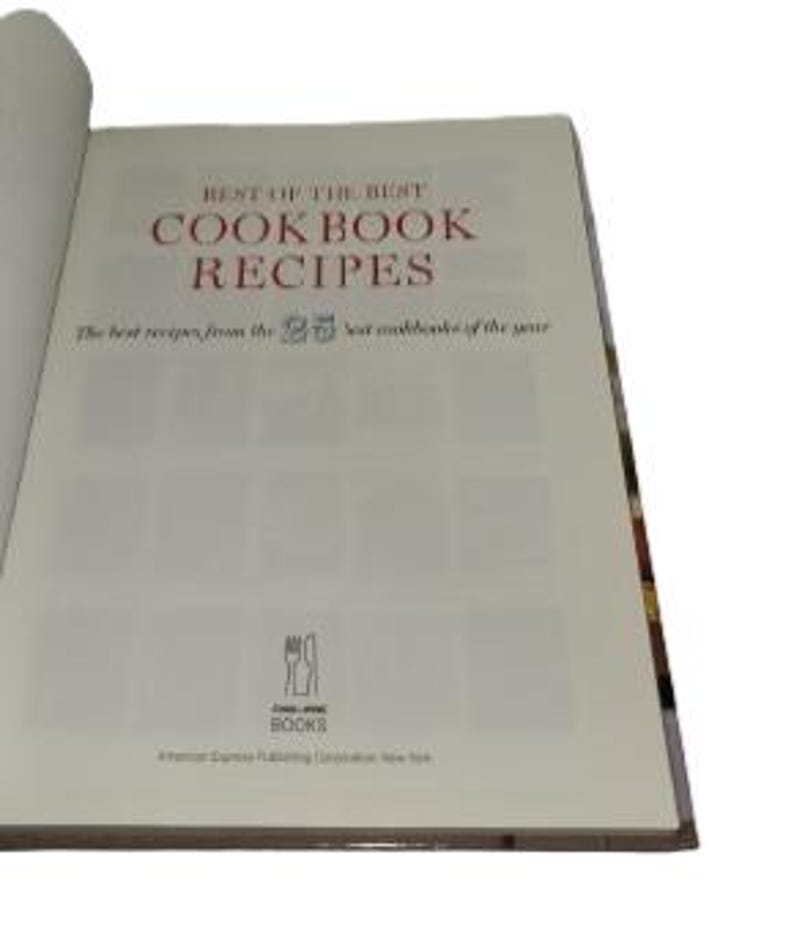 May include: Open cookbook titled "Best of the Best Cookbook Recipes." The cover features red text on a white background. The book is open to a page with the title and a subtitle, "The best recipes from the 25 best cookbooks of the year."