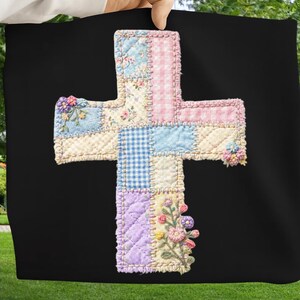 May include: A patchwork cross in pastel colors, including pink gingham, blue floral, and lavender quilted fabrics. The cross is embellished with embroidered flowers and set against a black background.