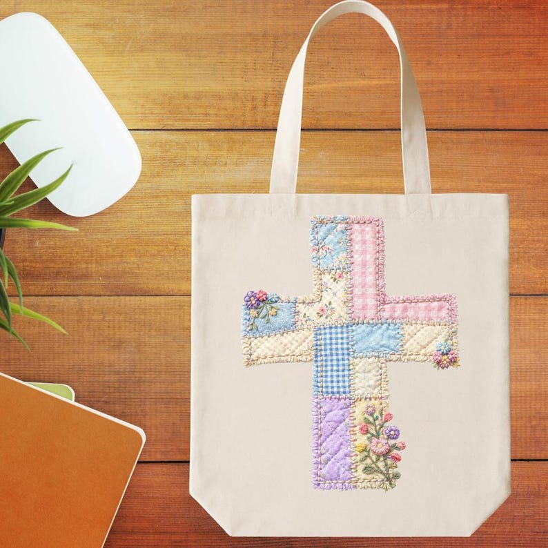 May include: Cream-colored tote bag featuring a patchwork cross design. The cross is made of various fabric patterns in pastel colors, including pink gingham, blue floral, and lavender. Small floral embellishments are placed on the cross.