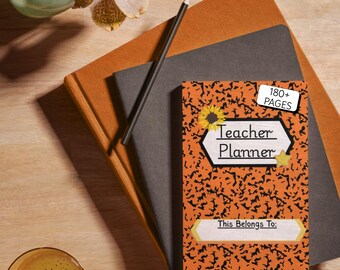 May include: A teacher planner with an orange cover featuring a black pattern and sunflower graphic. The planner is stacked on top of two notebooks and a pencil. A glass of liquid and a vase with flowers are also in the image.