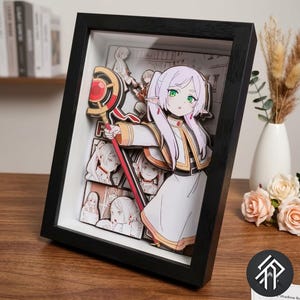 May include: A black framed anime-style artwork. The artwork features a layered design creating a 3D effect, depicting a character with lavender hair and green eyes holding a staff. The background shows other character illustrations. The frame is black.