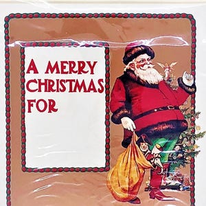 May include: Christmas card featuring Santa Claus in a red suit and hat, holding a sack of toys. The card has the text "A Merry Christmas For" in red letters. The border is brown with a red dotted design.