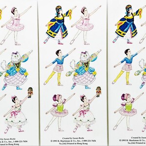 Könnte beinhalten: Bogen mit Aufklebern mit Illustrationen von Ballerinas in verschiedenen Kostümen. Die Ballerinas sind in verschiedenen Posen dargestellt, einige halten Gegenstände. Die Farbpalette umfasst Blau, Rosa, Gelb und Weiß. Der Text "Created by Susan Beebe" ist sichtbar.