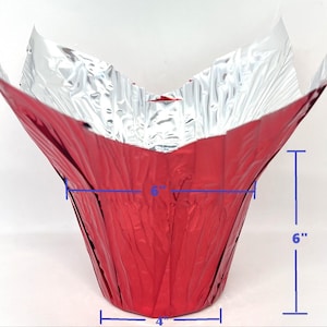 May include: A red, cone-shaped container with a silver interior. The container is 9 inches tall, 6 inches wide at the top, 4 inches wide at the base, and 6 inches deep. The container is made of a shiny, crinkled material.