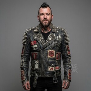 May include: A distressed black leather jacket with silver spikes on the shoulders and collar. The jacket features multiple patches with various designs and a belt at the waist. The jacket is worn over a black shirt.