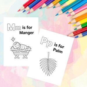 May include: Two white coloring pages with the text "Mm is for Manger" and "Pp is for Palm" are displayed. The "Manger" page shows a baby in a manger. The "Palm" page shows a palm leaf. Colored pencils are in the background.