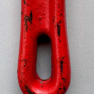 May include: Close-up of a red metal tool with a loop. The tool has a textured surface with areas of black wear and tear. The @moabmavericktools watermark is visible at the bottom.