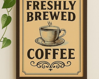 May include: Framed coffee sign with the words "FRESHLY BREWED COFFEE" in a vintage style. The sign features a detailed illustration of a coffee cup and saucer. The frame is dark brown, and the background is tan.