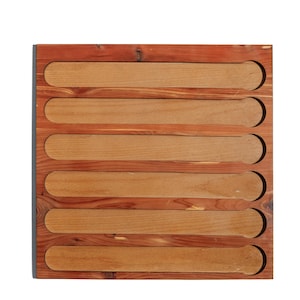May include: A wooden organiser featuring six rectangular slots. The frame is a darker reddish-brown, with the slots in a lighter shade of brown. The design is simple and functional, likely for storing items.