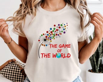Comfort Color Dandelion Flower 'The Game Of The World' T-Shirt, 2026 Soccer Graphic Tee