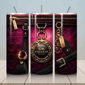 May include: A stainless steel tumbler with a design featuring a close-up of a Coach handbag. The design includes a zipper, gold hardware, black leather straps, and the Coach logo in gold. The background is a deep pink.