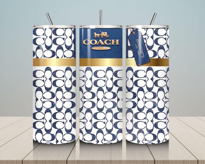 May include: Three cylindrical tumblers with straws featuring a white and navy blue repeating logo pattern. The center tumbler displays the gold COACH NEW YORK logo and a carriage icon. A blue leather-style tag reads BISHOP'S EST 1941.