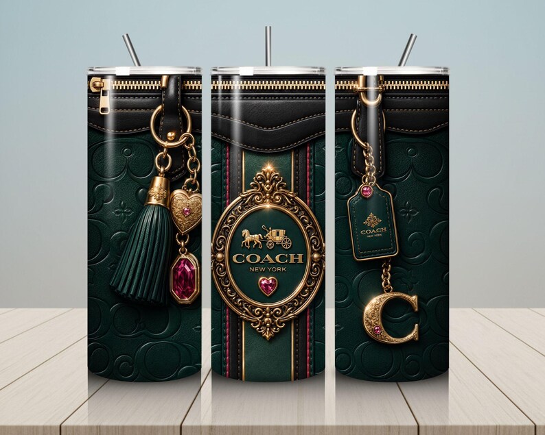 May include: A tumbler with a dark green leather-like design featuring gold accents and a zipper detail. The design includes a Coach New York logo, a heart-shaped charm, and a tassel. The tumbler has a silver straw.