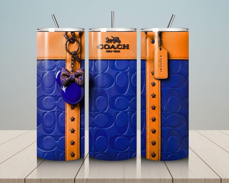 May include: Three cylindrical tumblers with straws featuring a blue embossed logo pattern, a tan leather-look band, and star studs. One tumbler displays a Coach logo, another a hanging bow charm, and the third a hanging leather-look luggage tag.