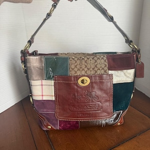 May include: A patchwork Coach handbag with a variety of colors and textures. The bag features a brown leather pocket with a gold turn-lock closure and the Coach logo. The shoulder strap is brown leather with gold-tone hardware.