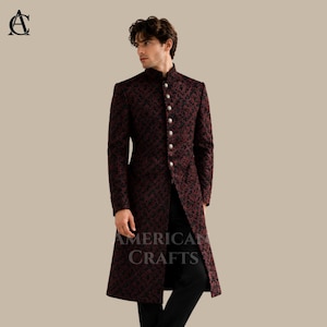 May include: A long-sleeved, knee-length coat in a deep burgundy and black patterned fabric. The coat features a high mandarin collar, a front placket with a vertical row of round silver-toned buttons, and a structured fit with long sleeves.