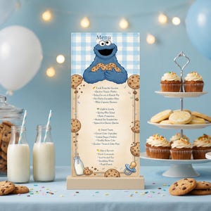 May include: A menu featuring the Cookie Monster holding cookies, with a blue and white checkered background. The menu lists various food items, with cookies and cupcakes on display. The scene is decorated with balloons and jars of cookies.