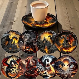 May include: A collection of eight circular coasters, each displaying a unique dragon illustration. The designs feature dragons in black, red, and orange hues, set against fiery backgrounds. A white cup of coffee rests on a matching coaster.
