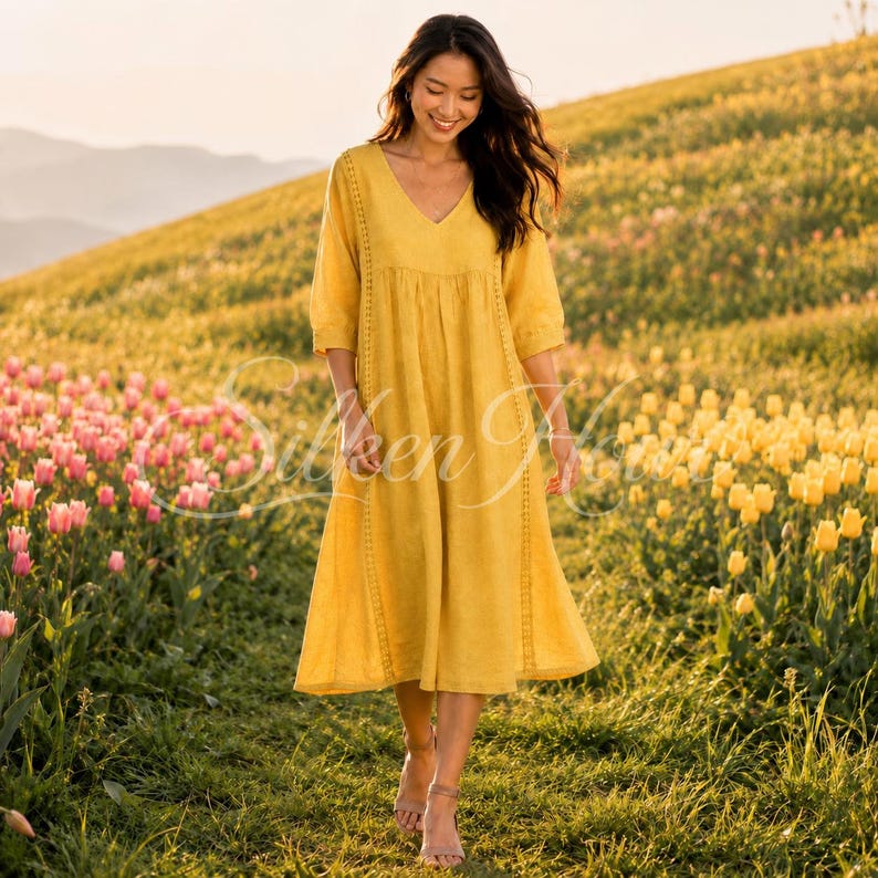 May include: A mustard yellow midi dress featuring a V-neckline, three-quarter length sleeves, and vertical lace trim detailing along the bodice. The dress has a loose, flowing silhouette that falls below the knees, crafted with a textured fabric.