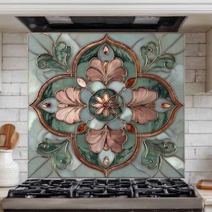 May include: A decorative kitchen backsplash with a floral design. The backsplash features a symmetrical pattern with green, copper, and pink hues. It is installed above a black gas stove, adding a touch of elegance to the kitchen.