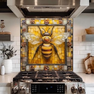 May include: A decorative kitchen backsplash featuring a large, detailed bee mosaic. The bee has yellow and brown stripes, with white wings, set against a yellow background. The mosaic is framed with a decorative border, adding a touch of artistry to the kitchen.