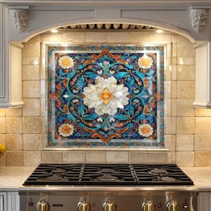 May include: A kitchen backsplash with a large floral mosaic design. The mosaic features a central white flower with orange and yellow accents, surrounded by blue and green foliage. The backsplash is above a stainless steel gas range.