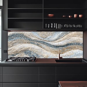 May include: A kitchen backsplash featuring a mosaic pattern of small, rectangular tiles arranged in flowing, wavy lines of cream, beige, and soft blue. The design creates a textured, undulating effect across the wall behind the stove and sink.